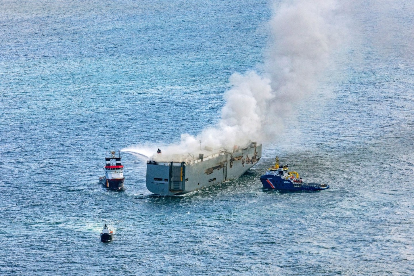 Eine Luftaufnahme zeigt einen deutschen Notschlepper(l), der das Feuer auf dem brennenden Frachter «Fremantle Highway» bekämpft.